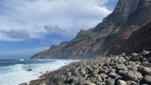 Experience the raw beauty of Kalalau Valley on Kauai’s Napali Coast. This breathtaking image captures the dramatic cliffs, powerful ocean waves, and rocky shoreline, showcasing Hawaii’s untouched wilderness.